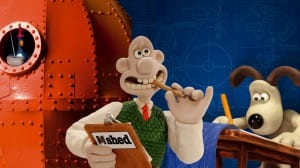Image showing Wallace holding a M Shed clipboard and Gromit drawing at a desk