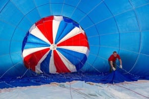 Photo of a man inside a blue hot air balloon