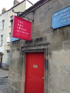 Image of a Red front door and red sign