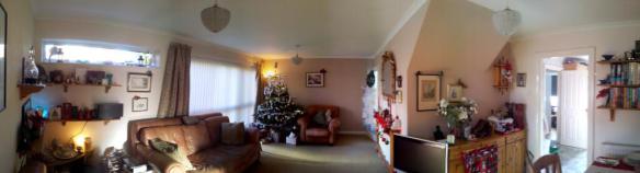 panoramic photograph of a living room with christmas decorations