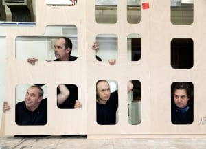 Men looking through multiple wooden window frames