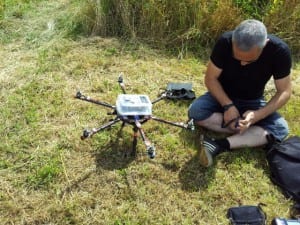 Photo of a man sat down working on a drone