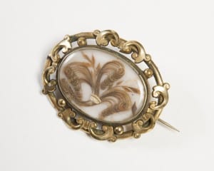 Victorian mourning brooch containing human hair in 'death: the human experience'