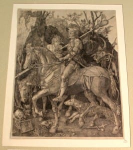 Black and white engraving of a man riding a horse with a personification of death next to him