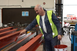 A man in high-vis painting 