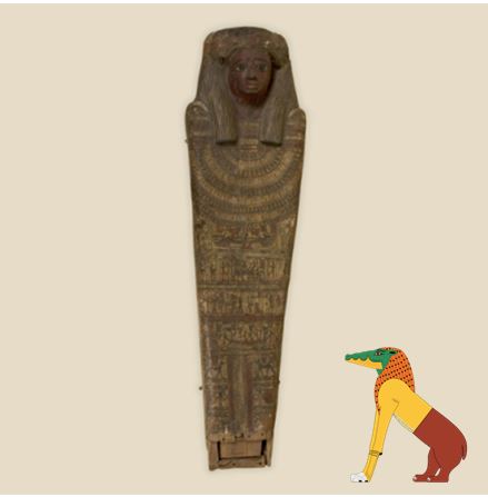 The lid of the Egyptian coffin belonging to Paty-hewty, accompanied by a cartoon version of an Ammit.