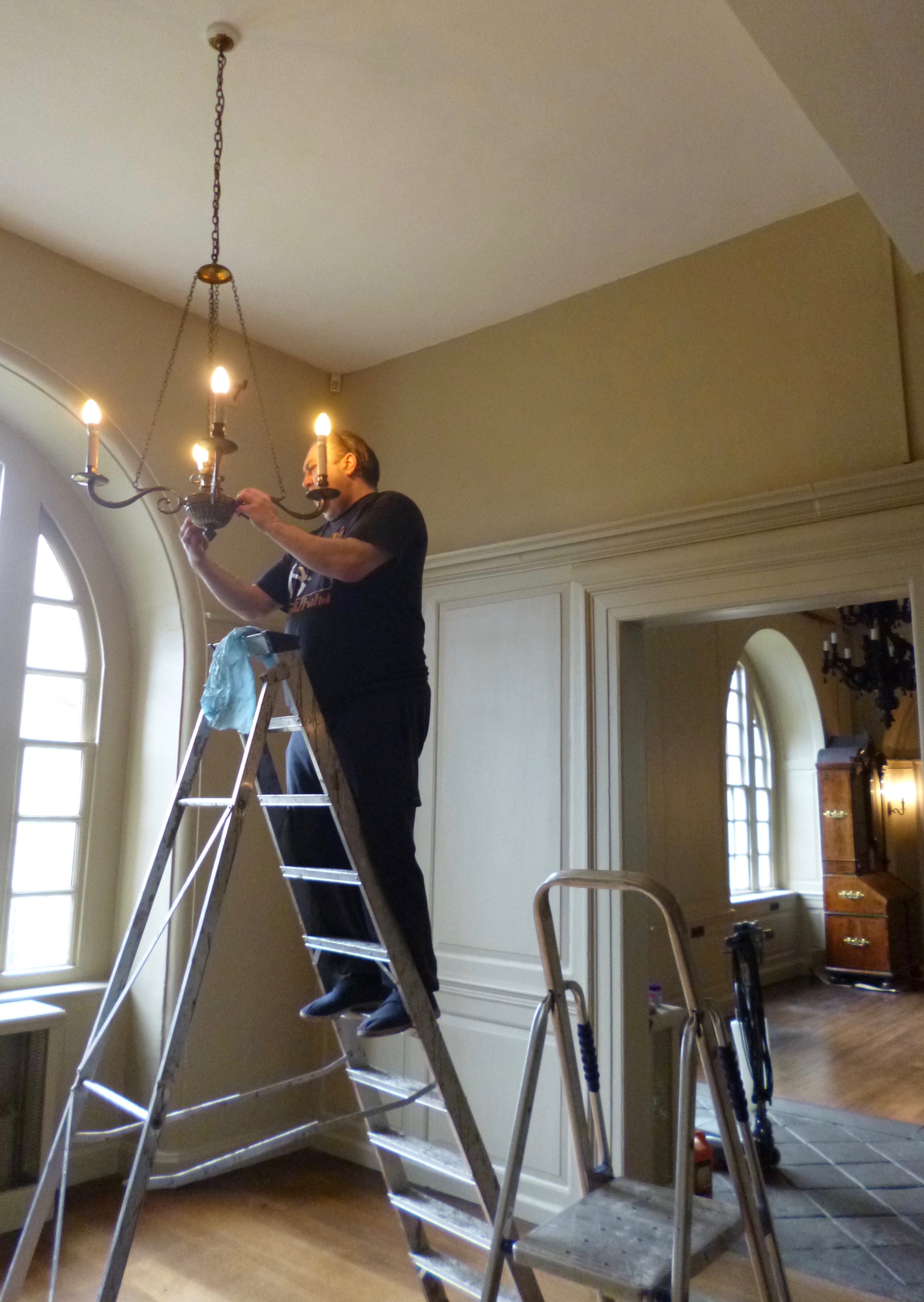 Chandeliers in the Reception Room being cleaned in time for the Red Lodge reopening.