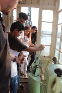Four young people in a crane cabin learning how to control it