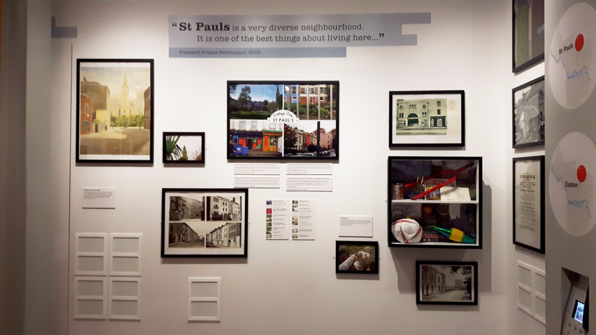 Photo of St. Paul's display in M Shed's Place Gallery, showing images and text about community life.