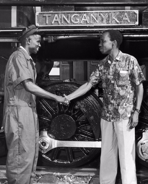 Black and white image showing Dr Julius Nyerere, first President of an independent Tanzania, greeting a train driver.