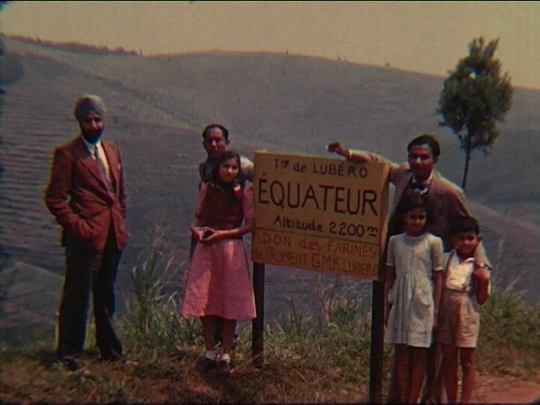 Image of three men and three children stood by a sign marking the equator (British Empire and Commonwealth Collection)