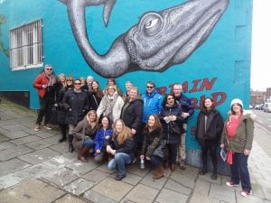 A group of 20 walkers in front of a graffiti whale on Park Row