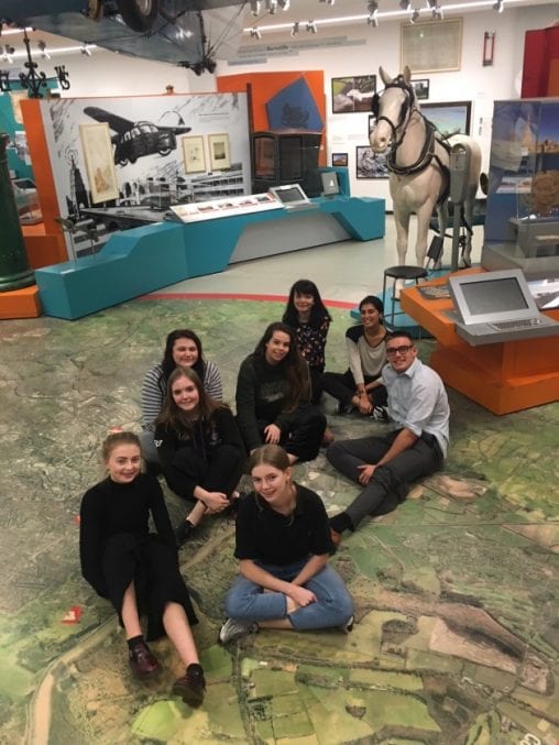 The Youth Panel (seven girls, one boy) sat on the giant map in M Shed