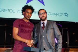 Mulue being presented with the ‘Arts & Culture Hero’ award by music producer Roni Size at the Bristol Young Heroes Awards
