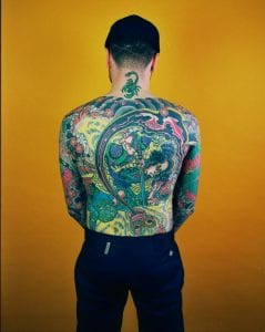 A man's heavily tattooed back
