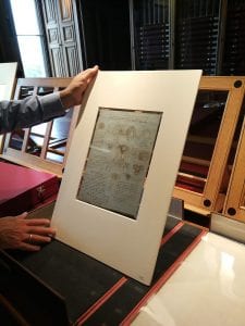 Martin Clayton holding up one of Leonardo da Vinci's drawings