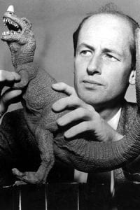 Ray Harryhausen holding a model of a Ceratosaurus