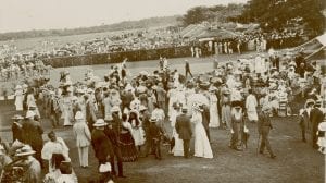 Photograph showing both British and Sri Lankan people milling around in their best attire at the races