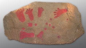 The Pool Farm Cist Slab - a stone slab covered in red footprints