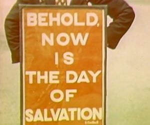 A sandwich board that reads 'Behold now is the day of salvation'