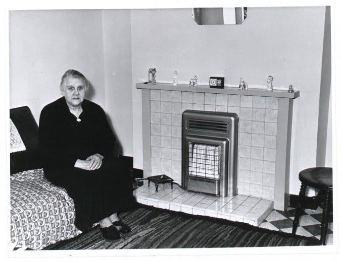 Photograph of a Bristol lady and her immaculate mantelpiece in the 1960s
