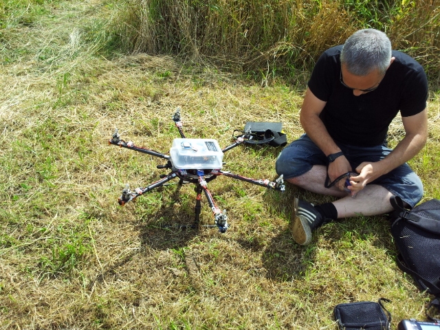 Photo of a man sat down working on a drone