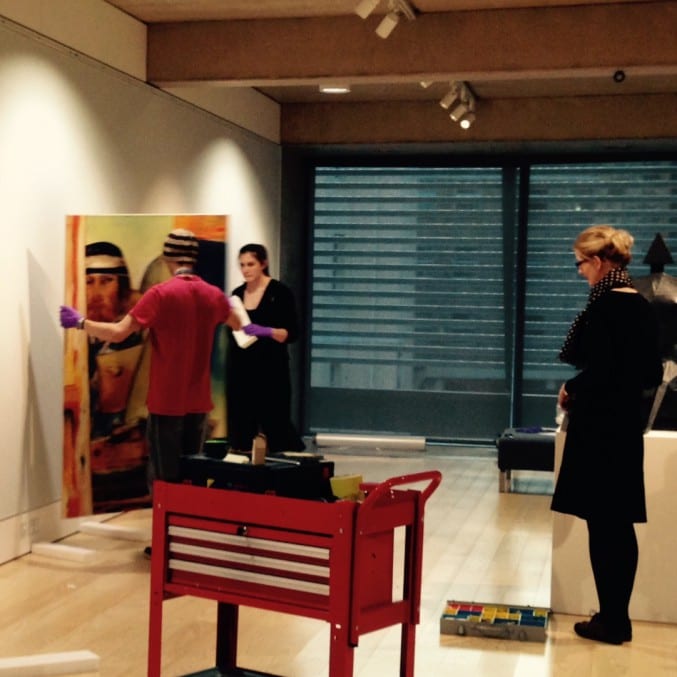 Photo of curators installing An Open Window exhibition at The Wilson, Cheltenham