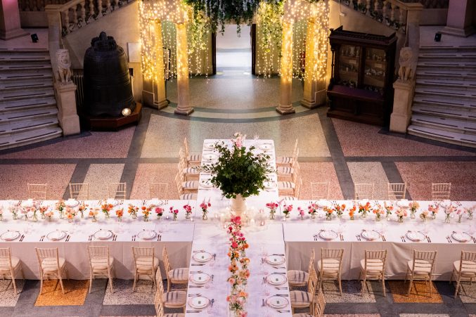 A large dinning table set out in the shape of a cross