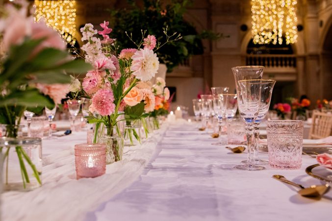 A table set up for a wedding with flowers.