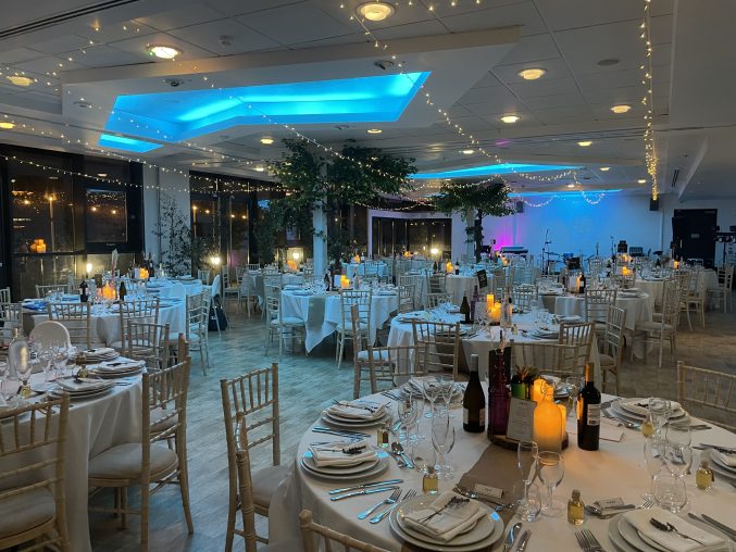 m shed event suite at night decorated with fairy lights for a wedding reception
