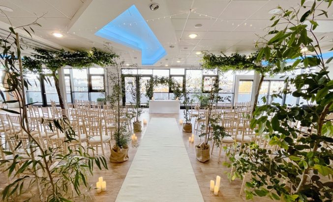 m shed event suite decorated with plants and candles for a wedding ceremony