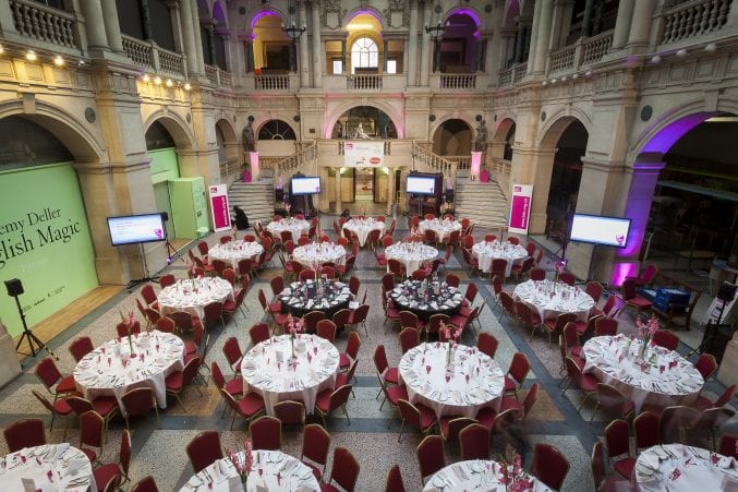 Tables laid for dinner in the rear hall of Bristol Museum & Art Gallery