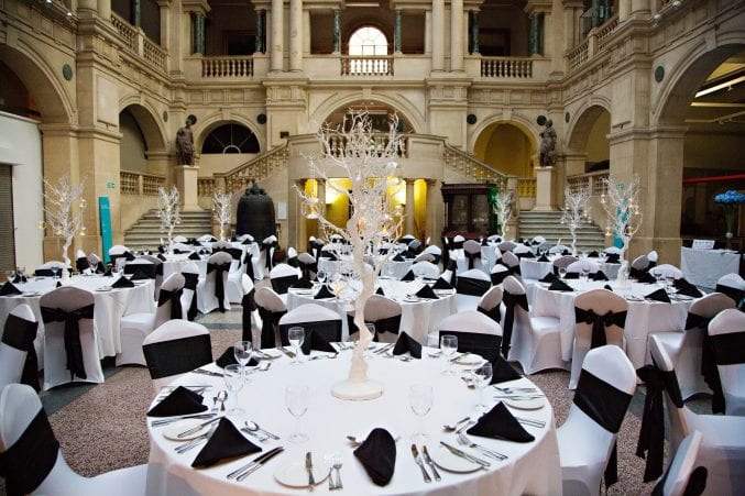 Tables laid for dinner in the rear hall of Bristol Museum & Art Gallery