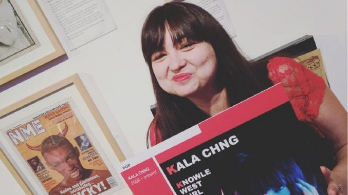 KALA CHNG holding her EP in the Bristol Music exhibition at M Shed