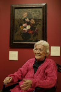 A portrait taken from a Dementia friendly creative cafe - a woman sitting in front of a painting in the Old Masters gallery