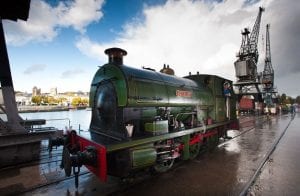 A green steam train called Henbury on the harbourside outside M Shed