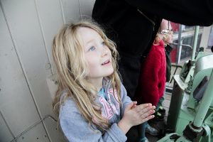 A child enjoys a trip in the cab of one of the cranes. 