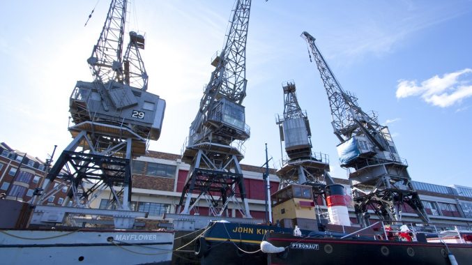 All four of the M Shed cargo cranes alongside boats in the Bristol harbour