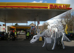 A large Stegosaurus bike outside a Shell petrol station