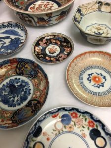 Close up photo of colourful porcelain plates and bowls 