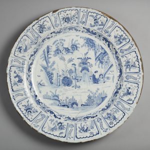 The front of a delftware plate with an intricate blue pattern
