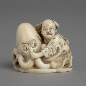 This netsuke carving shows a fisherman wrestling with an octopus. The fisherman’s expression suggests that he knows he is in trouble. 