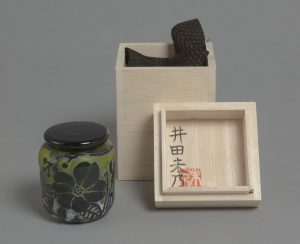 A glass tea caddy decorated with the wild flowers and foliage local to the western Izu area.