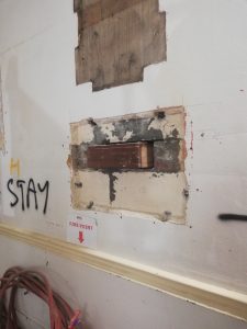 A patchy looking wall revealing a time capsule hidden inside
