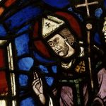 A close up of a stained glass window depicting Saint Blaise