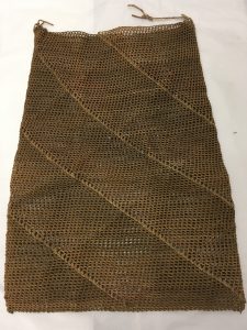Bag made of looped and netted vegetable fibre with diagonal stripes woven into the body.