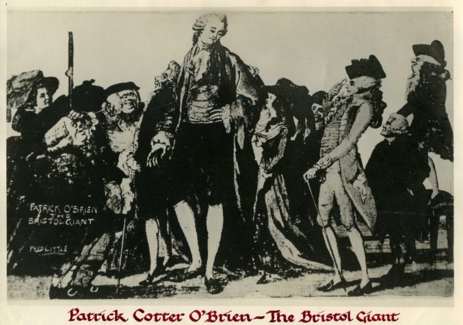 This is a postcard of O'Brien, probably from an ink drawing. It places him in the centre of the picture, among lots of much shorter people. Many lean towards him, and some look curious, others aggressive. Most of the men wear wigs, and the women wear big hats. O'Brien looks peaceful despite this, and wears a short pale wig, a frilly neckscarf or cravat, a waistcoat, breeches, long socks and shoes.