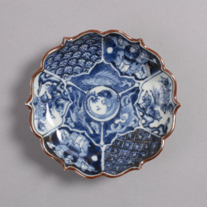 Blue and white delftware plate with gold trimming.