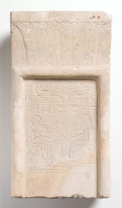 Ancient Egyptian pale coloured stone with hieroglyphics carved into it. 