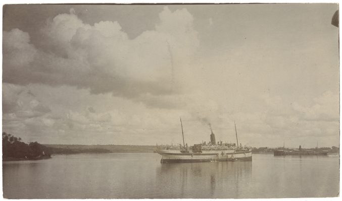 faded black and white photo of a boat on water